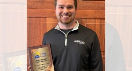 Austen holding IDA Top 100 Award