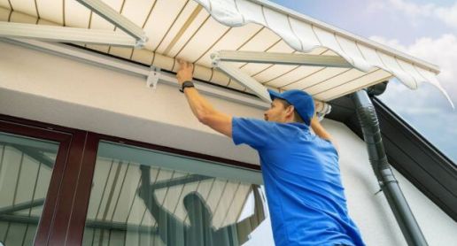 technician installing an awning