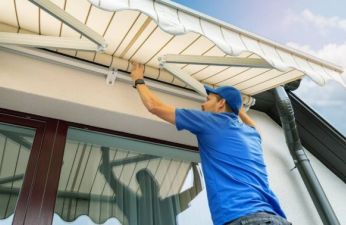 technician installing an awning